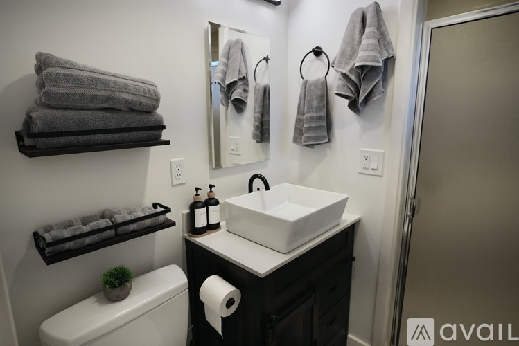 A bathroom with a white sink and a toilet.