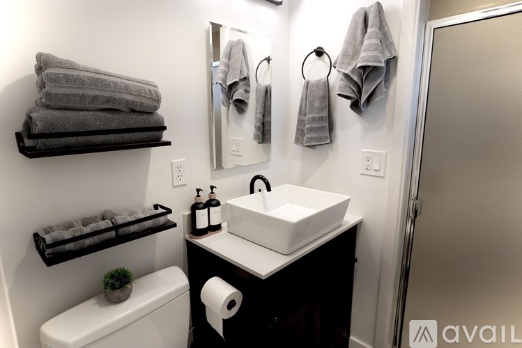 A bathroom with a white sink and a toilet.