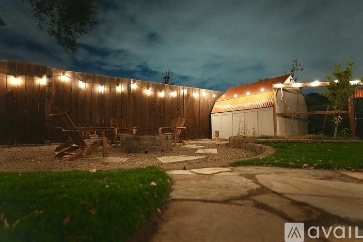 A backyard with a wooden fence and a patio area.