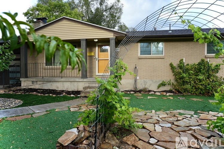 A house with a stone pathway leading to the front door.