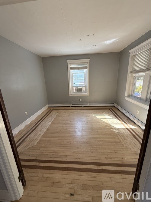 A room with wooden flooring and a window.