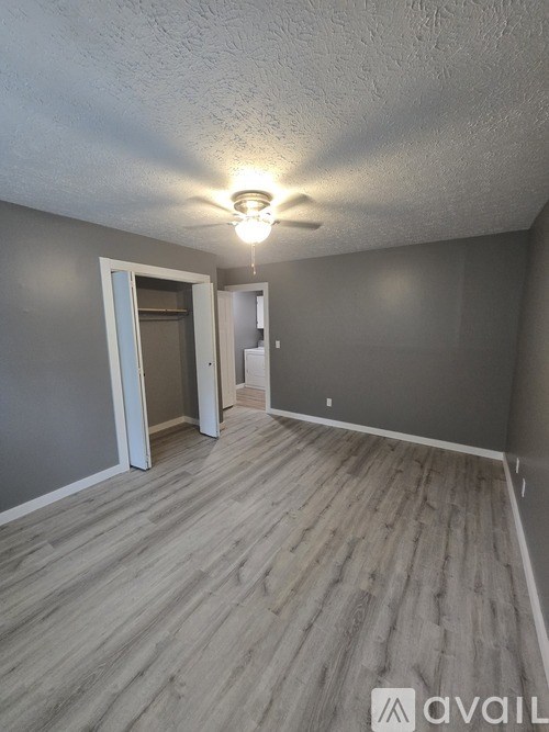 A room with a light on and a doorway leading to another room.