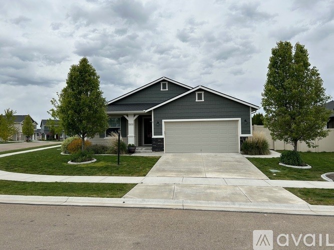 A house with a grey garage door is available for sale.