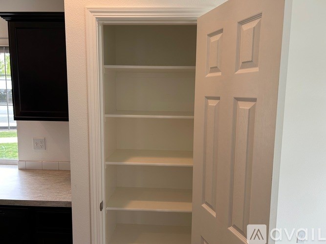 A white door with a handle is open.