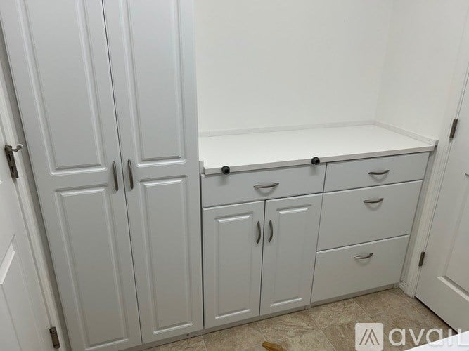 A white cabinet with drawers and a shelf.
