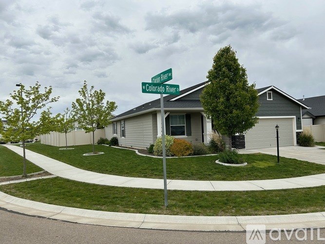 A house with a green street sign in front of it.