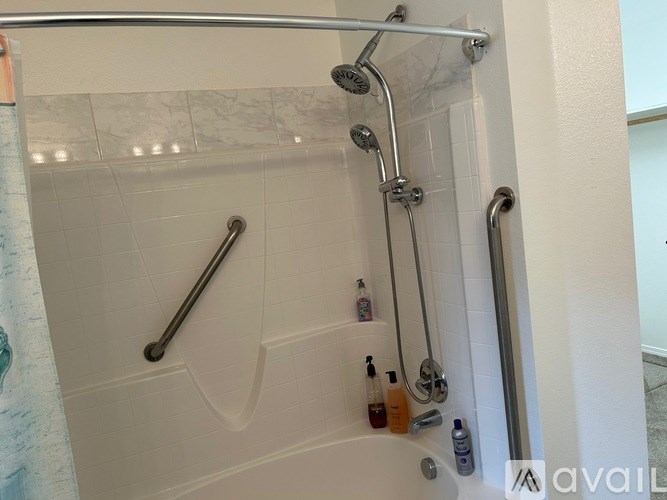 A shower with a glass door and a glass shelf above it.
