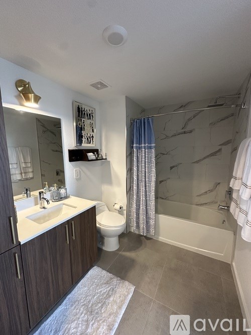 A bathroom with a toilet, sink, and shower.