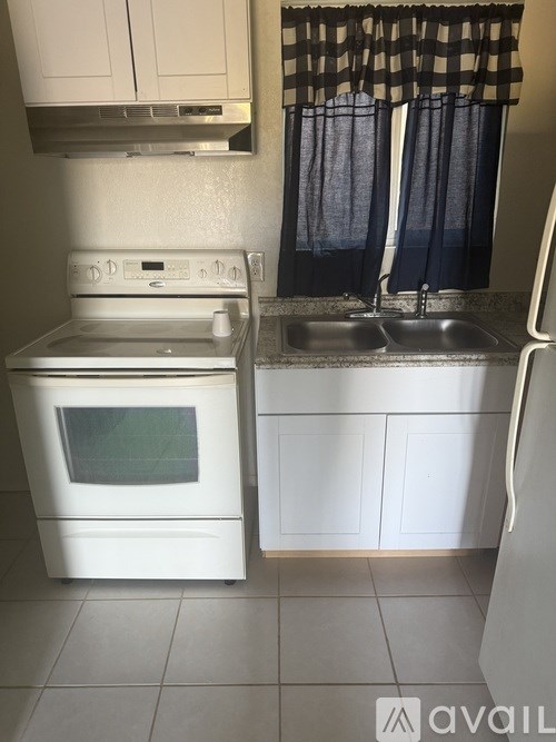 A white oven and sink in a kitchen.