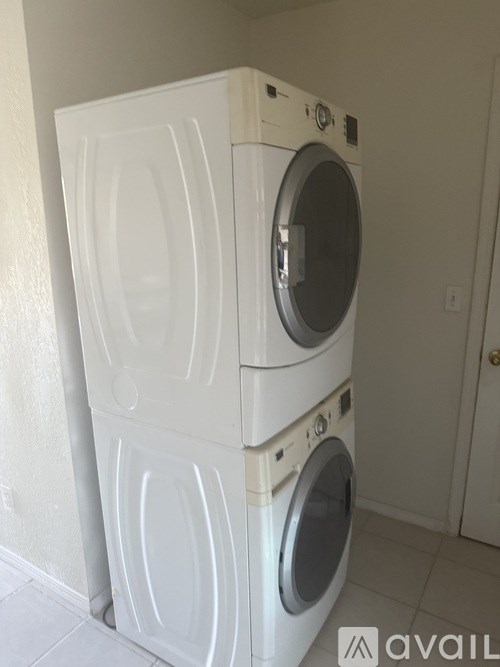 A white washing machine and dryer stacked on top of each other.
