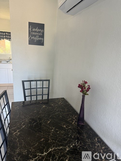 A black chair sits in front of a wall with a sign that says "Humans Changing Everything".