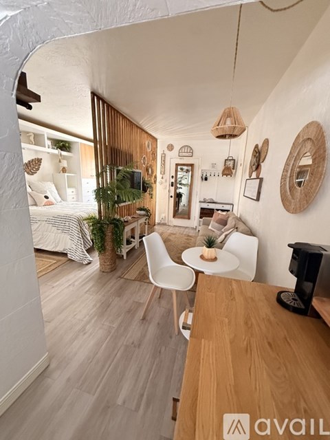 A modern living room with a white chair and a wooden table.