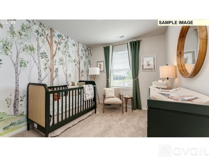 A baby's room with a crib, chair, and a wallpapered wall.