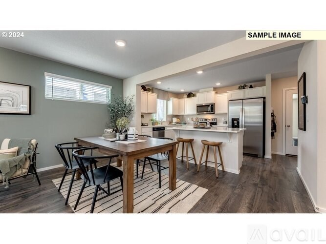 A modern kitchen with a dining table and chairs.