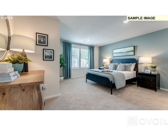 A bedroom with a large bed, a nightstand, and a dresser with a lamp on top.