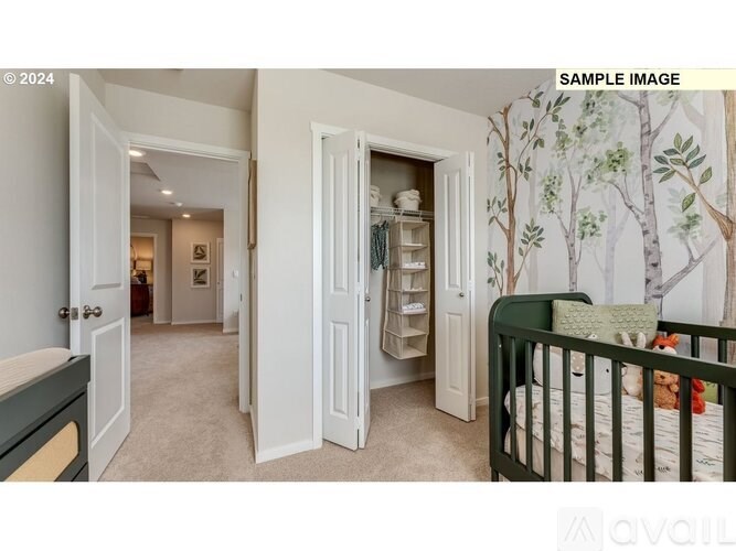 A baby's room with a crib and a wallpapered wall.