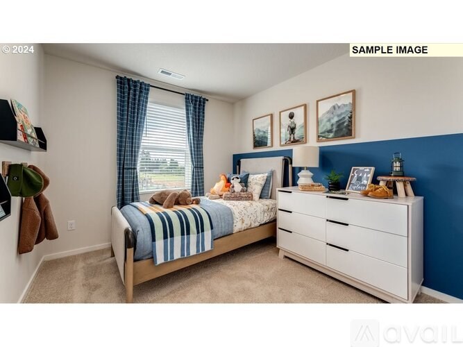 A bedroom with a bed, dresser, and window with curtains.
