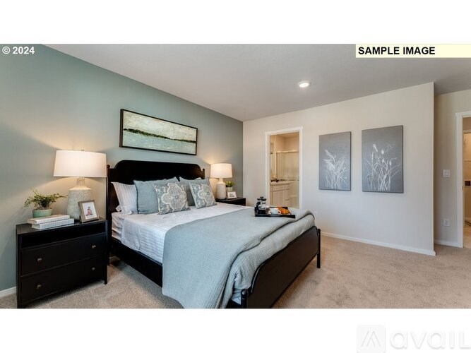 A bedroom with a bed, nightstand, and two wall art pieces.