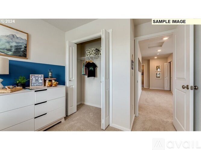 A hallway with a blue accent wall and a white door.