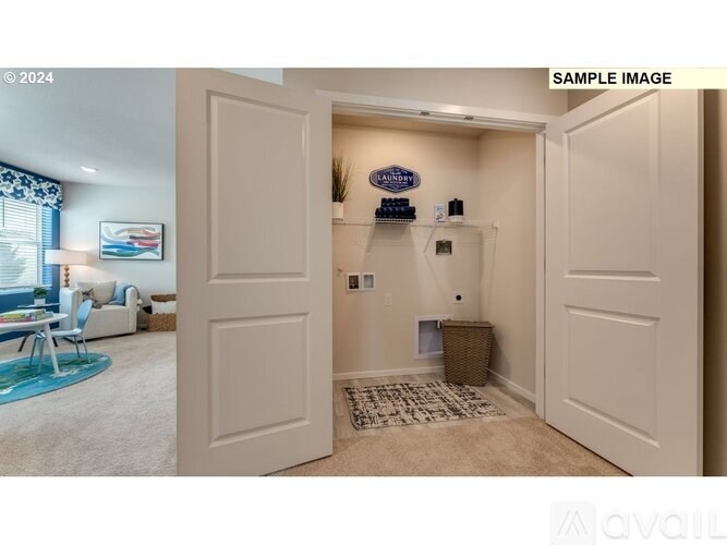 A room with a white door and a carpet on the floor.