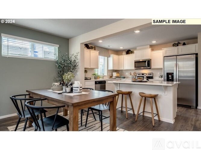 A modern kitchen with a dining table and chairs.
