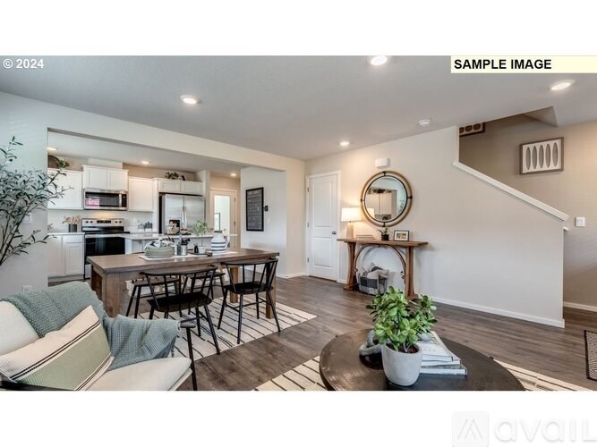 A modern kitchen with a dining table and chairs.