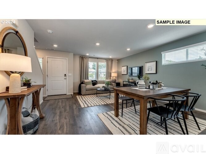 A modern dining room with a wooden table and chairs.
