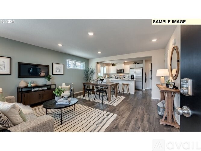 A modern living room with a striped rug and a coffee table in the center.