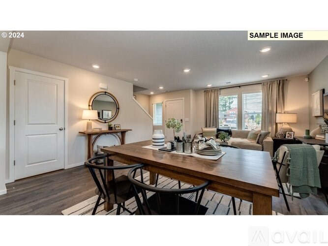 A dining room with a wooden table and chairs.