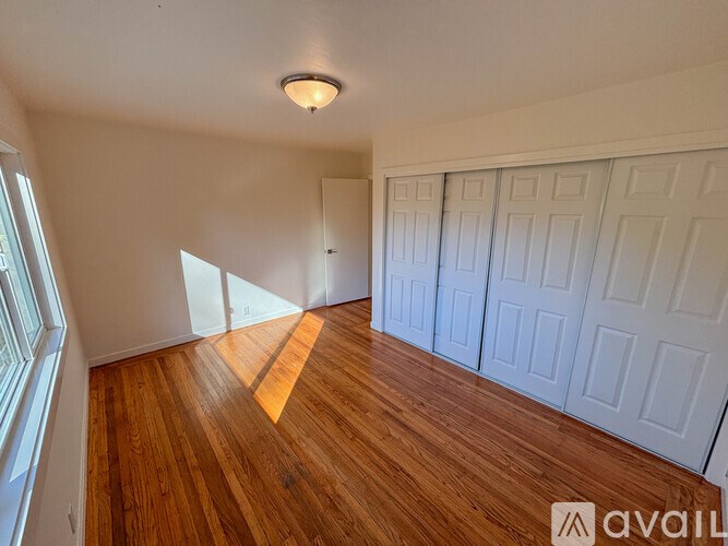 A room with wooden floors and white walls.