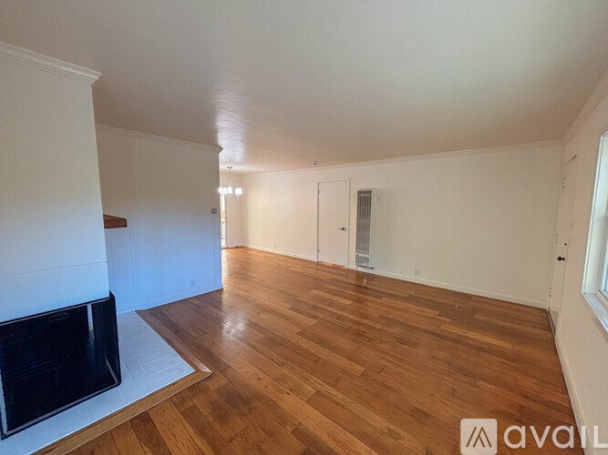 A room with wooden floors and a fireplace.