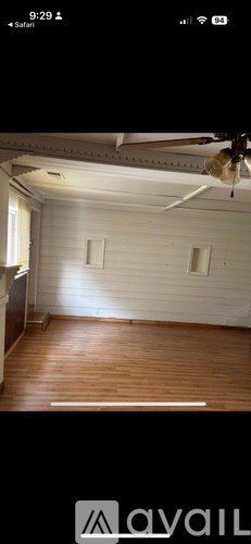 A room with wooden floors and white walls.