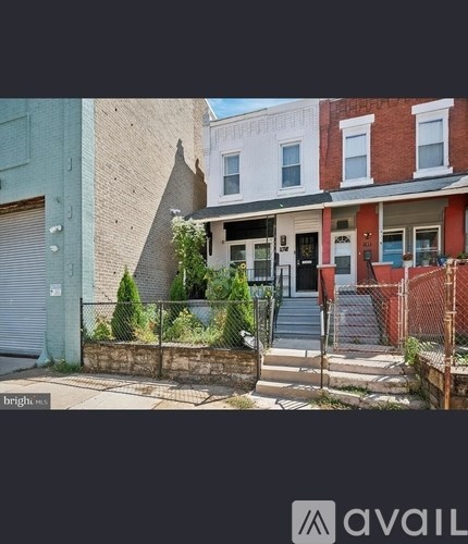 A house with a red brick exterior and a white door is shown.