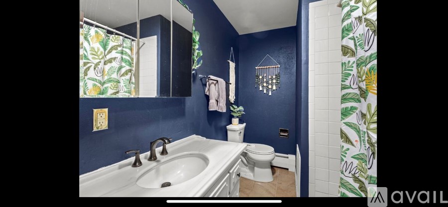 A bathroom with blue walls and a white sink.