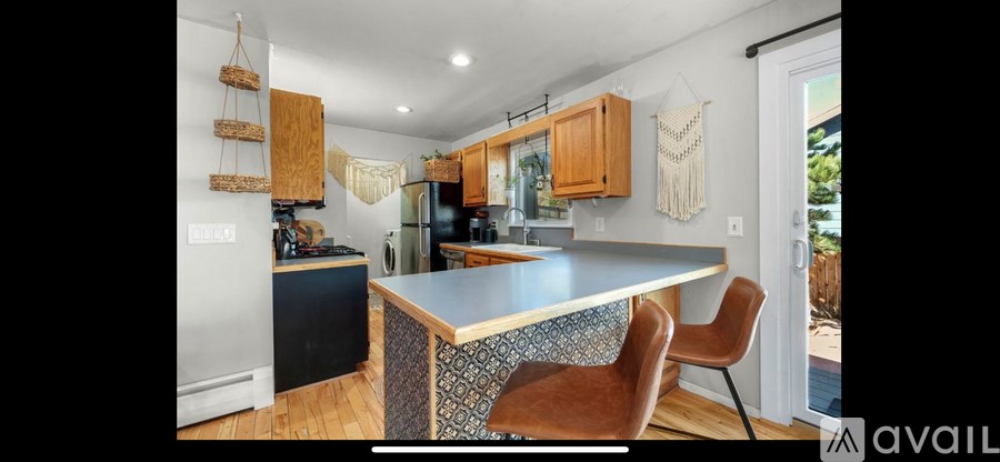 A kitchen with a large island and wooden cabinets.