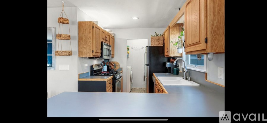 A kitchen with wooden cabinets and a refrigerator in the background.