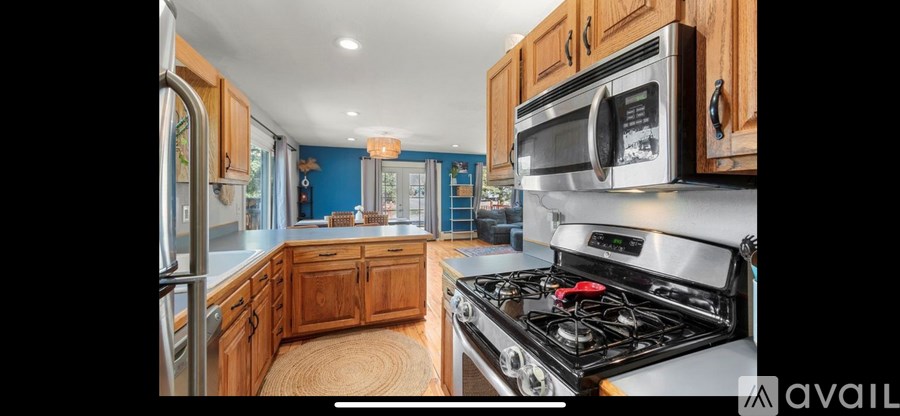 A kitchen with wooden cabinets and a stove top oven.