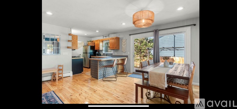 A kitchen with wooden floors and a large island in the middle.