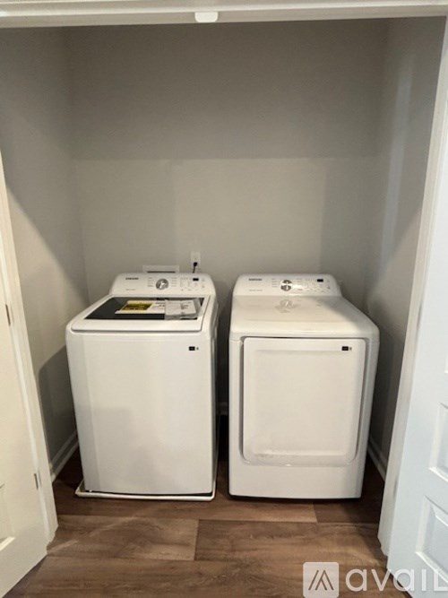 A white washing machine and dryer in a small laundry room.