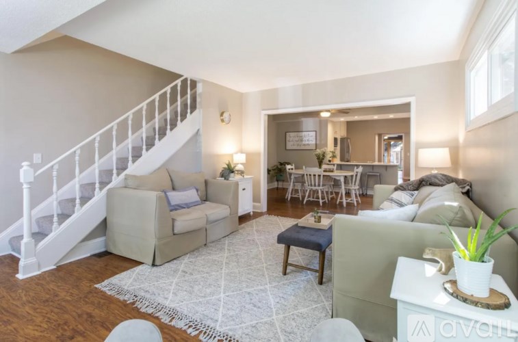 A living room with a staircase and a couch.