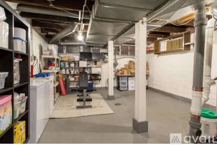 A room with a gym setup in a basement.
