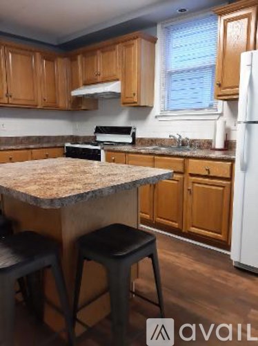 A kitchen with wooden cabinets and a granite countertop.