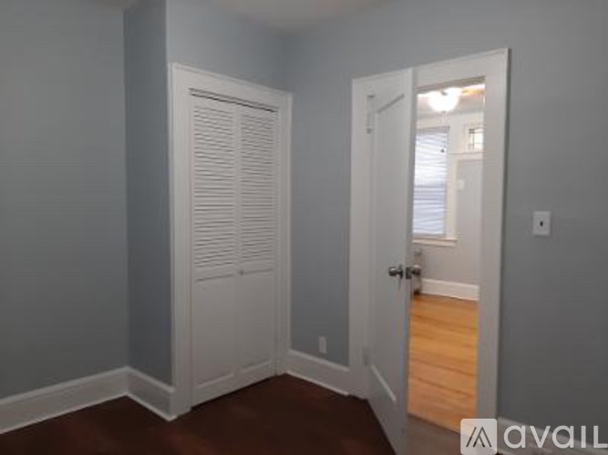 A room with a white door and a window.
