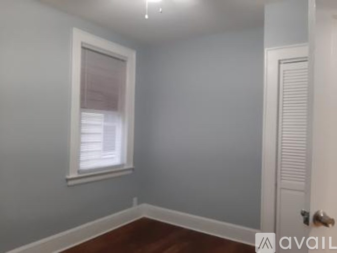 A room with a window and a door.