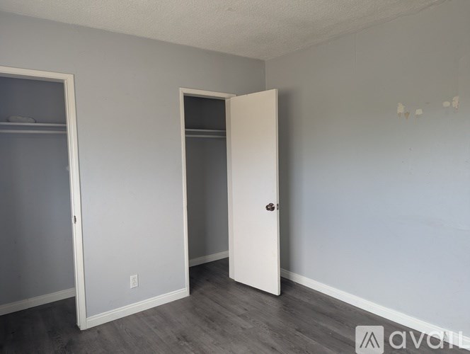 A room with a white door and a white closet door.