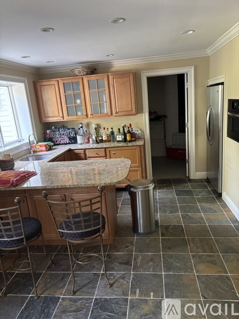 A kitchen with wooden cabinets and a granite countertop.