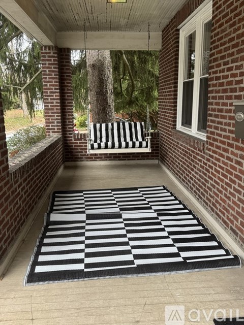 A two-story house with a front porch and a driveway.