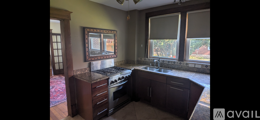 A kitchen with a stove top oven and a sink.