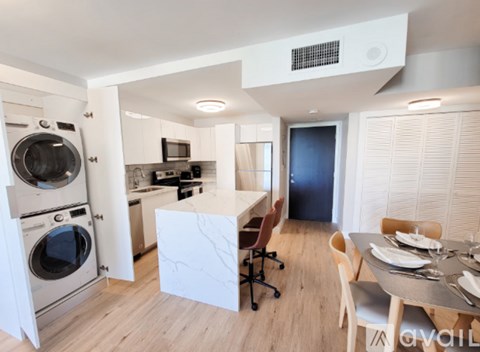 A modern kitchen with a dining table set for four.