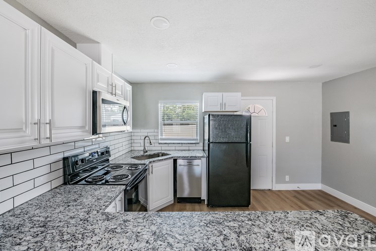 A kitchen with granite countertops and stainless steel appliances.